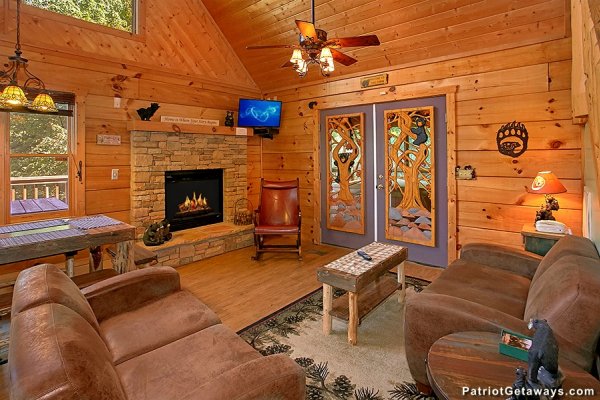 Vaulted living room with fireplace and TV at Picture Perfect Hideaway, a 2 bedroom cabin rental located in Pigeon Forge